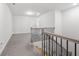 Upstairs hallway with neutral carpet, and wood and wrought iron banister at 6701 Cedar Glen Rd, Peachtree Corners, GA 30071