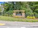 Stone monument sign that reads The Summit at Peachtree Corners with greenery at 6701 Cedar Glen Rd, Peachtree Corners, GA 30071