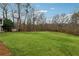 Large backyard featuring lush lawn and mature trees at 1438 Livingston Sw Dr, Marietta, GA 30064