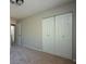 Bedroom features a closet with double doors, a ceiling fan, and neutral carpet at 3770 Mulkey Sw Cir, Marietta, GA 30008