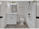 Bathroom features herringbone floors, a tub and shower, and a vanity with bronze fixtures at 436 Tarpley Ave, Bowdon, GA 30108