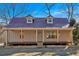 Charming home featuring a metal roof and a covered front porch with natural wood pillars at 436 Tarpley Ave, Bowdon, GA 30108