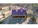 Charming home with covered porch, purple roof, and spacious lawn at 436 Tarpley Ave, Bowdon, GA 30108