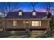 Charming single-story home featuring a metal roof, dormer windows, and a welcoming front porch at 436 Tarpley Ave, Bowdon, GA 30108