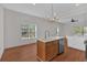 Bright kitchen boasts an island with a sink, lots of natural light, and wood flooring at 436 Tarpley Ave, Bowdon, GA 30108
