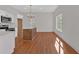 Modern kitchen features white cabinets, a center island, and stainless steel appliances at 436 Tarpley Ave, Bowdon, GA 30108