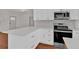 Well-equipped kitchen includes an oven, microwave, ample counter space, and wood floors at 436 Tarpley Ave, Bowdon, GA 30108