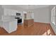 Modern kitchen with white cabinets, stainless steel appliances, and a center island at 436 Tarpley Ave, Bowdon, GA 30108