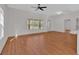 Bright, open-concept living room with laminate floors and large windows at 436 Tarpley Ave, Bowdon, GA 30108