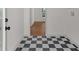 Mud room features black and white checkerboard floors and access to the laundry room at 436 Tarpley Ave, Bowdon, GA 30108