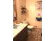Bathroom features a blue sink and toilet with unique decorative touches, plus patterned floor at 823 Mount Tabor Rd, Oxford, GA 30054