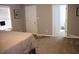 Bedroom with neutral walls, carpet, and window with connecting door to ensuite bathroom at 823 Mount Tabor Rd, Oxford, GA 30054