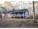 Single-story home featuring wood siding, white trim, and a cozy front porch at 823 Mount Tabor Rd, Oxford, GA 30054