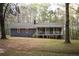 Charming exterior of a single-story home featuring a cozy front porch and manicured lawn at 823 Mount Tabor Rd, Oxford, GA 30054