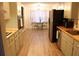 Galley kitchen featuring wooden countertops, light-colored cabinets, and stainless steel appliances at 823 Mount Tabor Rd, Oxford, GA 30054
