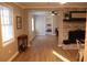 Comfortable living room with fireplace, opening to bedroom with hardwood floors and neutral paint at 823 Mount Tabor Rd, Oxford, GA 30054