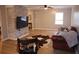 Cozy living room with a brick accent wall, comfortable seating, and hardwood floors at 823 Mount Tabor Rd, Oxford, GA 30054
