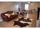 Comfortable living room featuring a leather sofa, rustic decor, and hardwood floors at 823 Mount Tabor Rd, Oxford, GA 30054