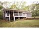 Covered porch with stairs leading to the backyard, perfect for outdoor relaxation at 823 Mount Tabor Rd, Oxford, GA 30054