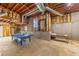 Unfinished basement with exposed ceiling, ping pong table, and basketball goal, offering customization and recreational potential at 920 Pine Grove Pointe Dr, Roswell, GA 30075