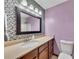 Bathroom featuring a vanity with updated fixtures, lighting, and tiled backsplash at 920 Pine Grove Pointe Dr, Roswell, GA 30075