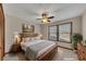Inviting bedroom suite features soft lighting, a ceiling fan, and two bright windows at 920 Pine Grove Pointe Dr, Roswell, GA 30075