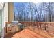 Outdoor deck with stainless steel gas grill, perfect for entertaining and enjoying the wooded scenery at 920 Pine Grove Pointe Dr, Roswell, GA 30075
