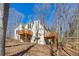 Rear exterior of home with multiple decks, offering great outdoor space with a tranquil wooded setting at 920 Pine Grove Pointe Dr, Roswell, GA 30075