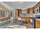 Well-lit kitchen with stainless steel appliances, wood cabinets and stone tile floors at 920 Pine Grove Pointe Dr, Roswell, GA 30075