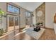 Bright living room boasts a stone fireplace, hardwood floors, and deck access at 920 Pine Grove Pointe Dr, Roswell, GA 30075