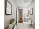 Bathroom featuring marble tile floors, a toilet, vanity, and a decorative plant at 1684 Braeburn Se Dr, Atlanta, GA 30316