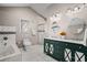Bright bathroom with modern green vanity, marble floors, a soaking tub, and a glass shower at 1684 Braeburn Se Dr, Atlanta, GA 30316