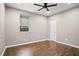 This bedroom features hard wood floors, a ceiling fan, a window and a white door at 1684 Braeburn Se Dr, Atlanta, GA 30316