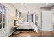 Bedroom boasts hardwood floors, ensuite, and exterior door to deck at 1684 Braeburn Se Dr, Atlanta, GA 30316