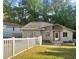Charming home with neutral exterior, a well-maintained lawn, and a white picket fence at 1684 Braeburn Se Dr, Atlanta, GA 30316