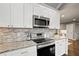 Modern kitchen with white cabinets, stainless steel appliances, and granite countertops at 1684 Braeburn Se Dr, Atlanta, GA 30316