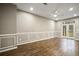 This living room has wood floors, a ceiling fan, and a double glass door to the outside at 1684 Braeburn Se Dr, Atlanta, GA 30316