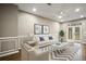 A furnished living room with white couches, a striped rug, and a glass door to the yard at 1684 Braeburn Se Dr, Atlanta, GA 30316