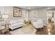 Living room with hardwood floors, white furniture, and easy access to other rooms at 1684 Braeburn Se Dr, Atlanta, GA 30316