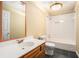 Well-lit bathroom with tiled shower and modern vanity featuring a decorative framed mirror at 2901 Soapstone Ct, Powder Springs, GA 30127