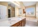 Bathroom with dual sinks, a soaking tub, and natural light at 2901 Soapstone Ct, Powder Springs, GA 30127