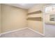 Small bedroom with built-in shelves and a window overlooking the backyard at 2901 Soapstone Ct, Powder Springs, GA 30127