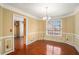 Elegant dining room with classic moldings, a chandelier, and hardwood floors at 2901 Soapstone Ct, Powder Springs, GA 30127