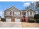 Charming two-story home featuring gray siding, brick accents, and a well-manicured lawn at 2901 Soapstone Ct, Powder Springs, GA 30127