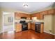 Traditional kitchen featuring wood cabinets, granite countertops, and modern black appliances at 2901 Soapstone Ct, Powder Springs, GA 30127