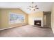 Inviting living room with a cozy fireplace, vaulted ceiling, and a large window at 2901 Soapstone Ct, Powder Springs, GA 30127