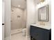 Bathroom with white subway tile walk-in shower, hexagonal tile floor and a blue vanity at 1208 Thomas Rd, Decatur, GA 30030