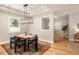 Bright dining room with modern light fixture and view into another room at 1208 Thomas Rd, Decatur, GA 30030