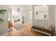 Welcoming entryway featuring hardwood floors, bench seating, and a decorative mirror at 1208 Thomas Rd, Decatur, GA 30030