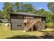 Exterior back elevation featuring a wooden deck, stairs, and manicured backyard at 1208 Thomas Rd, Decatur, GA 30030
